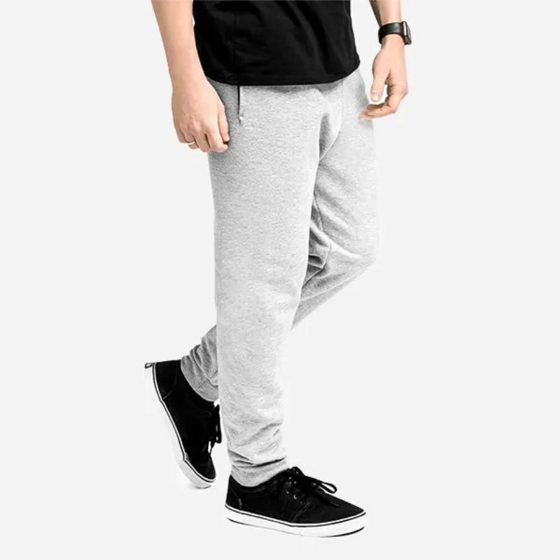 Model in plain heather-gray jogger sweatpants and a black tee, the blank for a sweatpants mockup